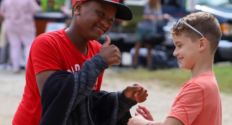Two young people signing to eachother.