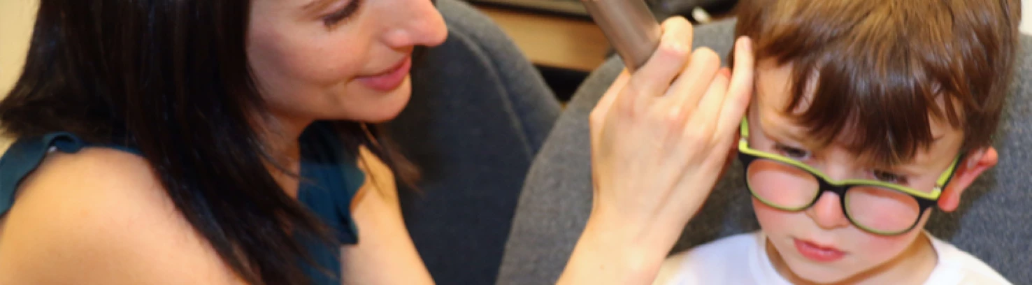 Audiologist testing a child