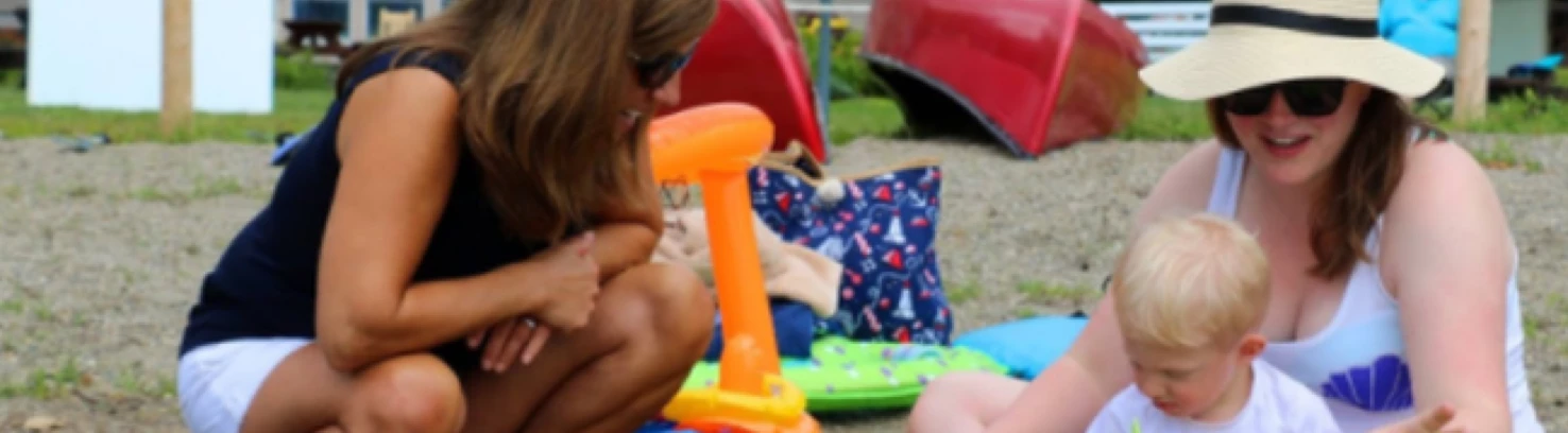 Two adults and a child on the beach