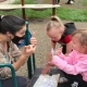 Teacher and a child signing to eachother on a playground