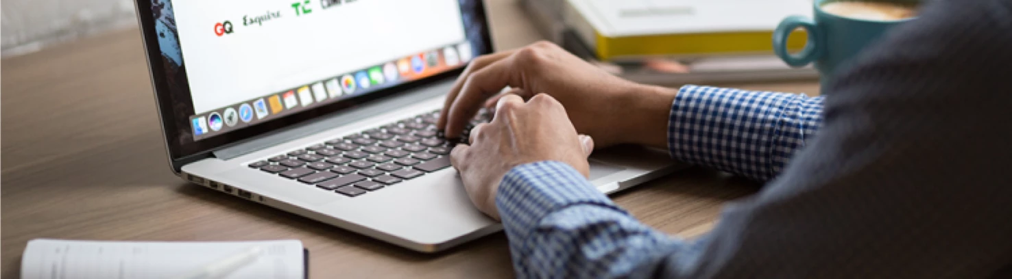 Looking over the shoulder of someone using a laptop