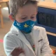 A child in a mask and doctor's coat
