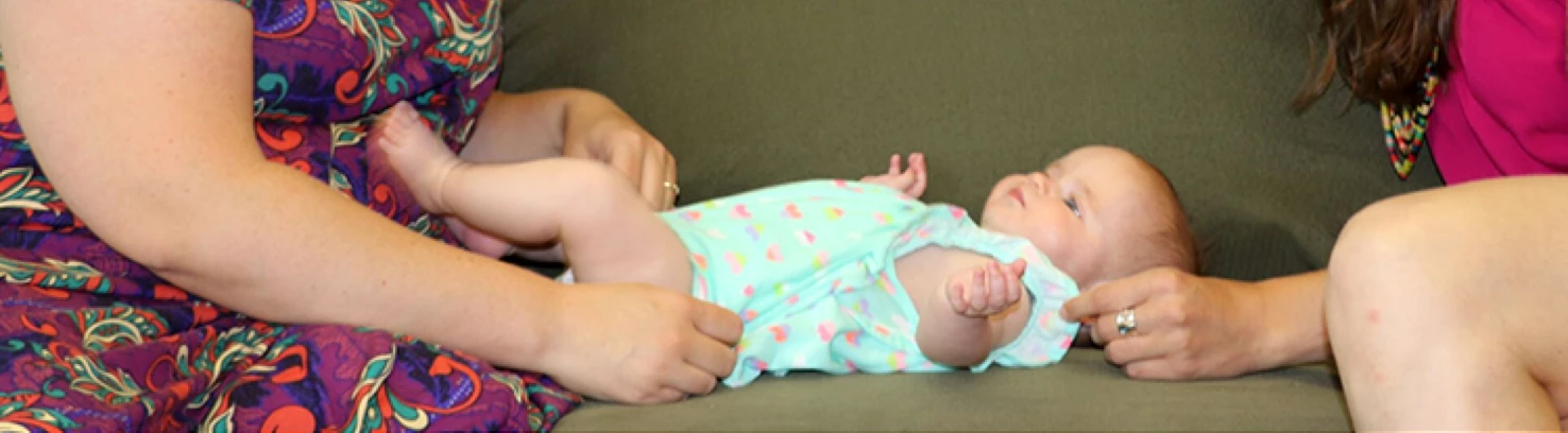 Two adults and a baby on a couch