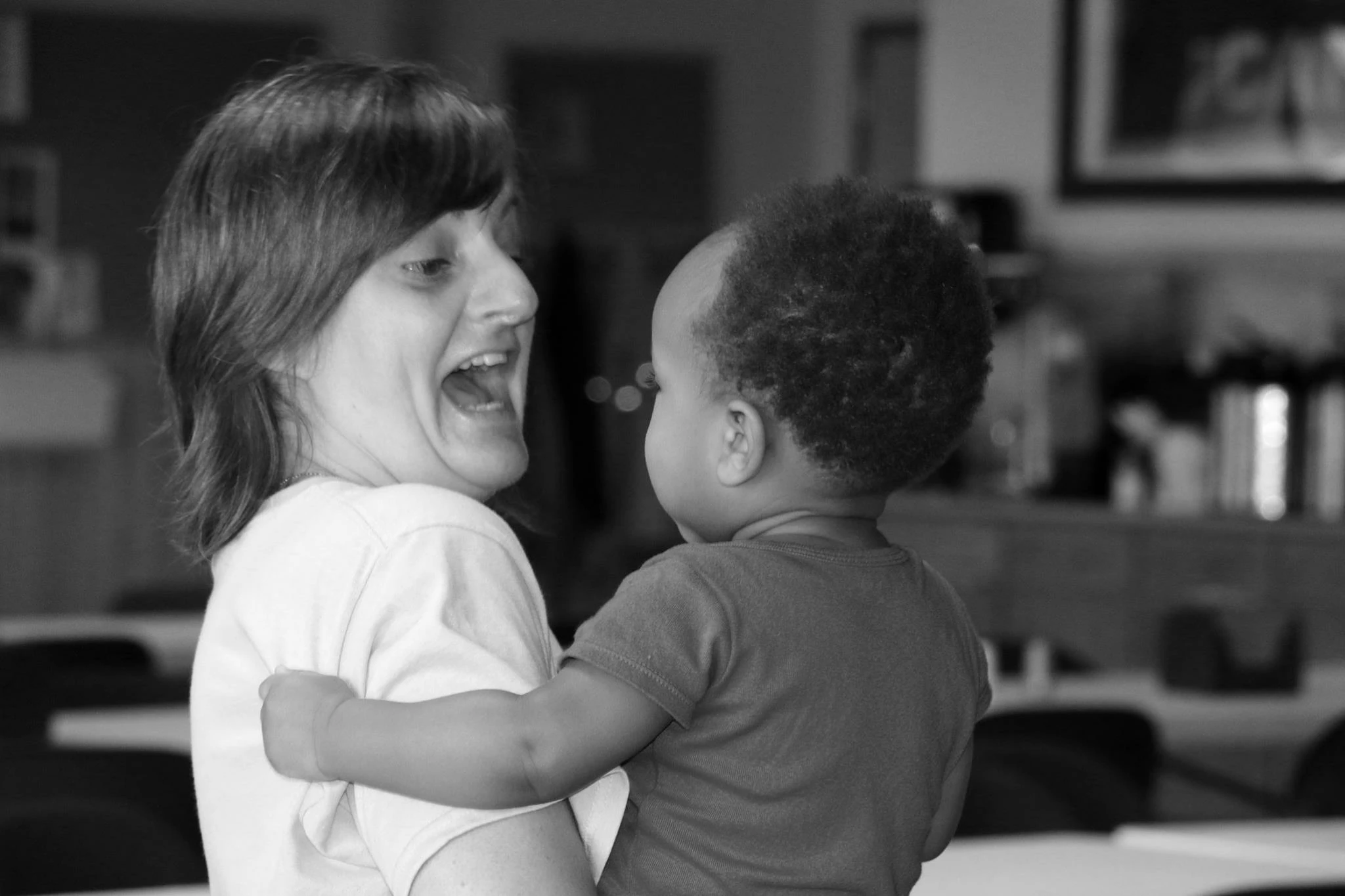 A person laughing with a baby.